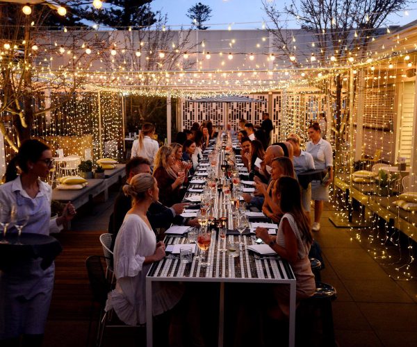 An evening function is hosted at the Cottesloe Beach Hotel, with guests enjoying dinner under decorations of fairy lights