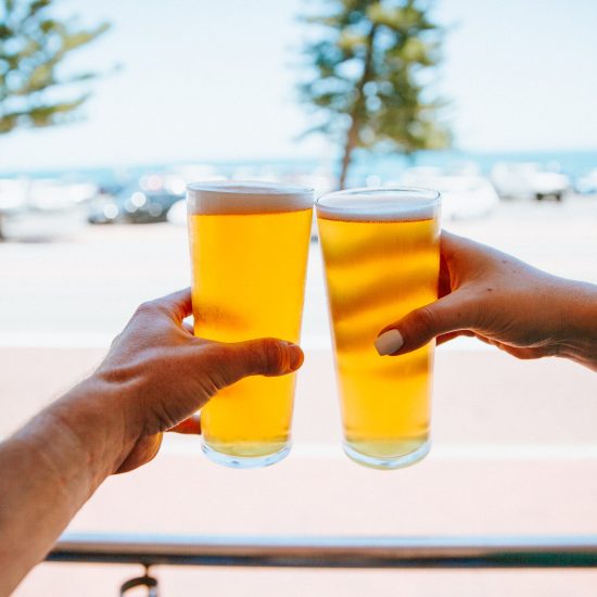 Guests at the Cottesloe Beach Hotel Verandah Bar enjoy pints of beer together